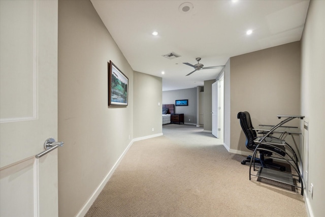 carpeted home office with ceiling fan