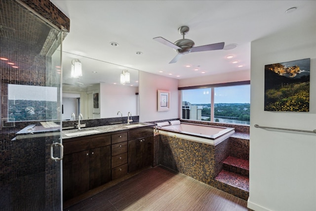 bathroom with vanity, ceiling fan, shower with separate bathtub, and hardwood / wood-style floors