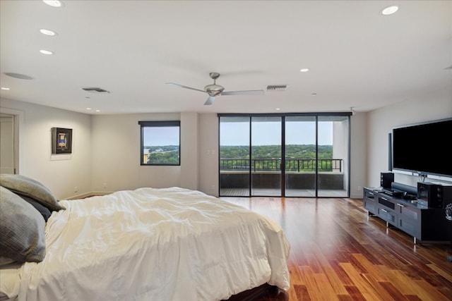 bedroom with access to exterior, ceiling fan, hardwood / wood-style flooring, and multiple windows