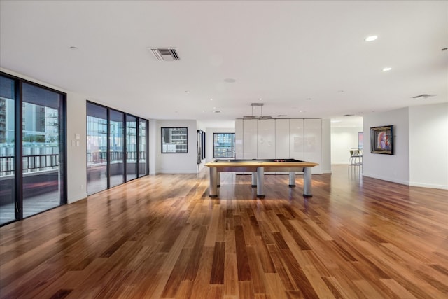 kitchen with hardwood / wood-style flooring, white cabinets, expansive windows, and billiards