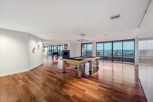 recreation room featuring light wood-type flooring, expansive windows, and pool table