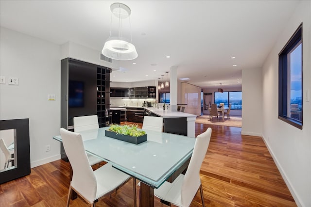 dining space with wood-type flooring