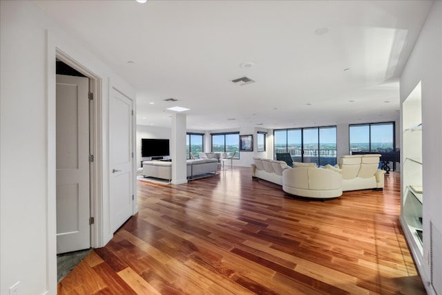 unfurnished living room with hardwood / wood-style flooring and expansive windows