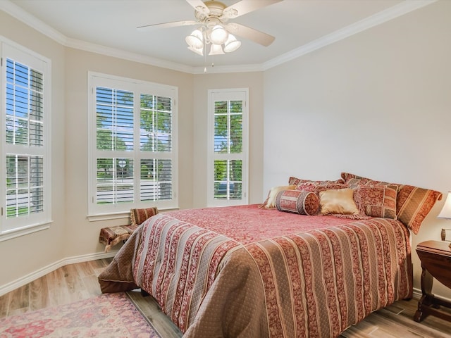 bedroom featuring crown molding, hardwood / wood-style flooring, and ceiling fan