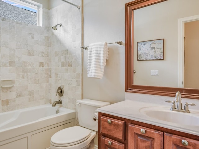 full bathroom featuring vanity, tiled shower / bath combo, and toilet