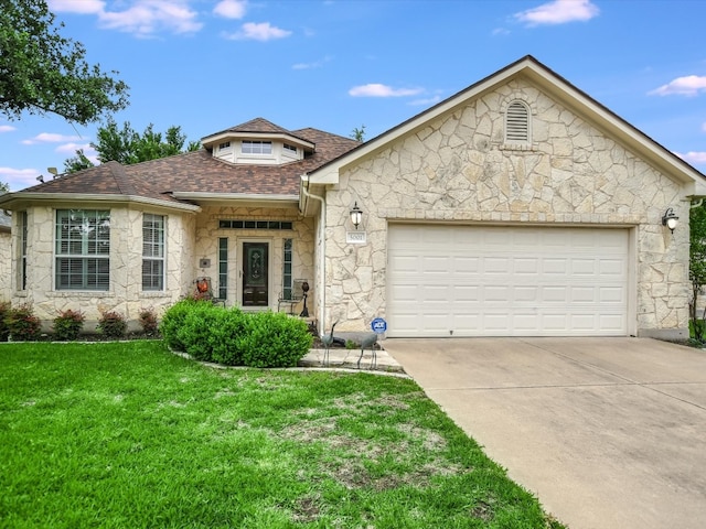 view of front of house featuring a garage and a front yard