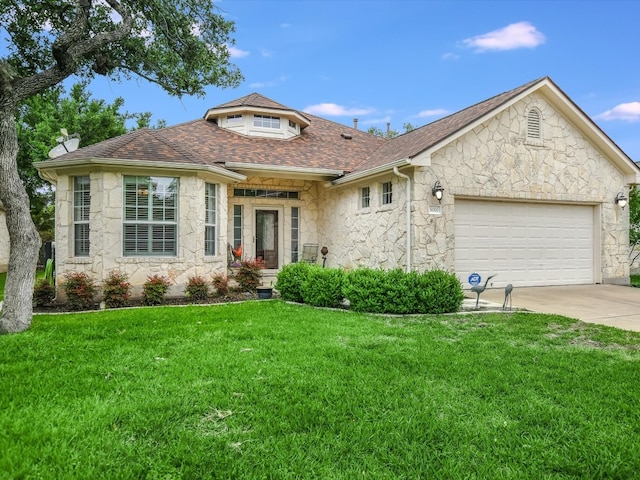 view of front of property with a front lawn and a garage