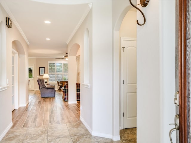 corridor featuring crown molding and light hardwood / wood-style flooring