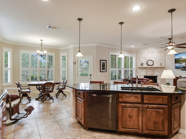 kitchen featuring plenty of natural light, a stone fireplace, sink, and dishwasher