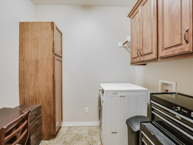 laundry area with washer / clothes dryer and cabinets