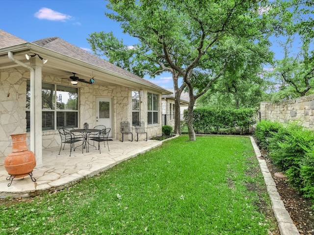 view of yard with a patio area and ceiling fan