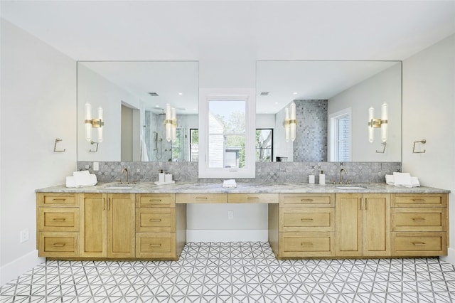 full bathroom featuring baseboards, backsplash, vanity, and walk in shower