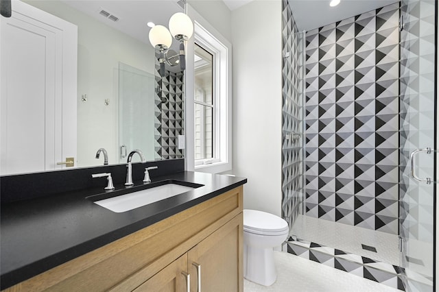 bathroom featuring toilet, a shower with door, a notable chandelier, tile patterned flooring, and vanity