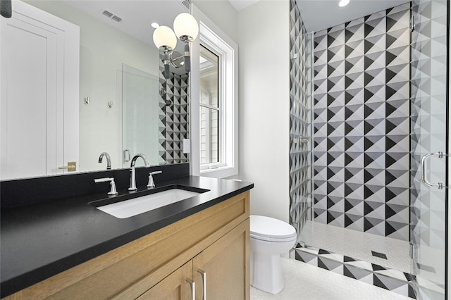 bathroom featuring toilet, a notable chandelier, vanity, visible vents, and a shower stall