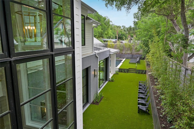 view of property exterior with a balcony and fence