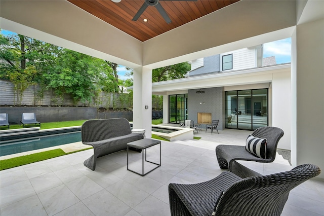 view of patio featuring a fenced in pool, fence, and a ceiling fan