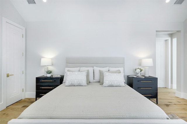 bedroom featuring vaulted ceiling and hardwood / wood-style flooring