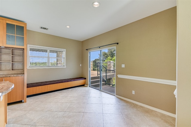 spare room with light tile floors