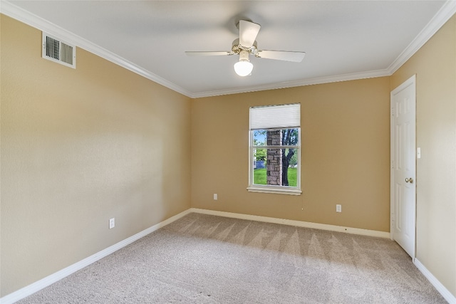 empty room with ceiling fan, carpet, and ornamental molding