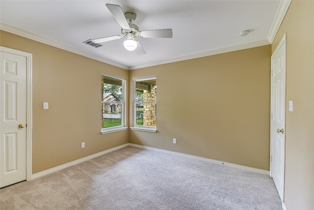 spare room featuring carpet flooring, ceiling fan, and ornamental molding