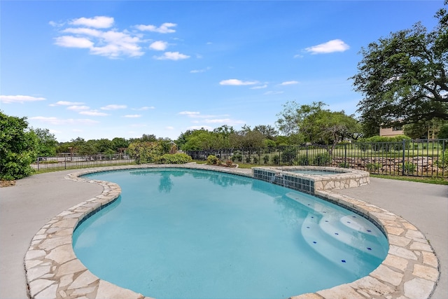 view of swimming pool featuring an in ground hot tub