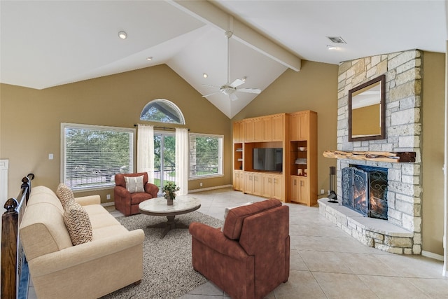 living room with beamed ceiling, ceiling fan, a healthy amount of sunlight, and a fireplace