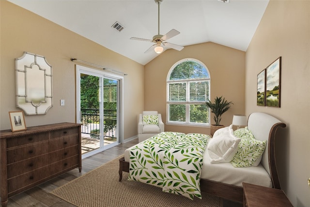 bedroom featuring vaulted ceiling, multiple windows, access to exterior, and dark wood-type flooring