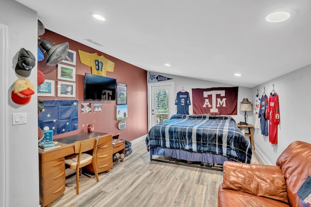 bedroom with wood-type flooring and lofted ceiling