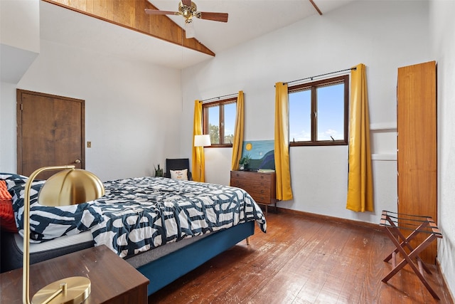 bedroom with wood-type flooring, high vaulted ceiling, and ceiling fan