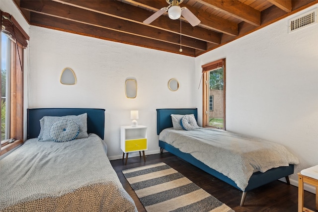 bedroom with beamed ceiling, dark hardwood / wood-style flooring, ceiling fan, and wood ceiling