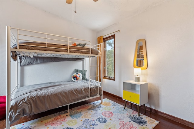 bedroom with dark wood-type flooring and ceiling fan