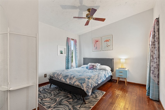 bedroom featuring dark hardwood / wood-style flooring, ceiling fan, a textured ceiling, and lofted ceiling