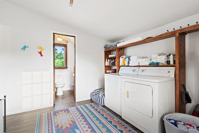 clothes washing area featuring washer and dryer and dark hardwood / wood-style floors