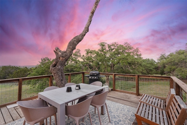 deck at dusk with grilling area