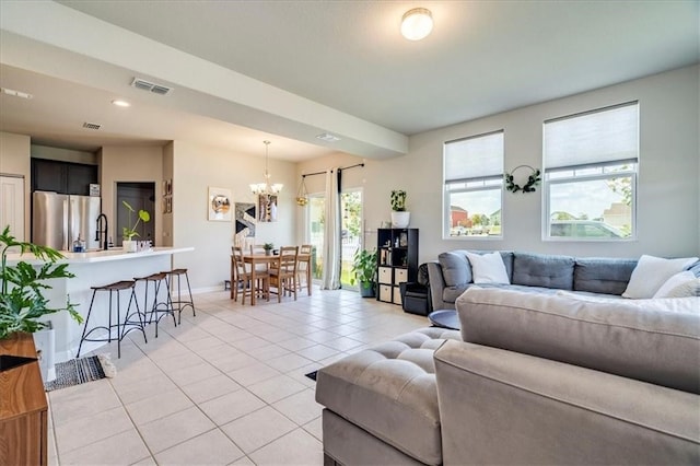 living room featuring a notable chandelier and light tile floors