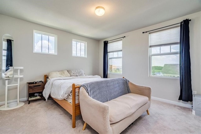 carpeted bedroom with multiple windows