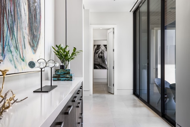 hall with a wealth of natural light and light tile patterned flooring