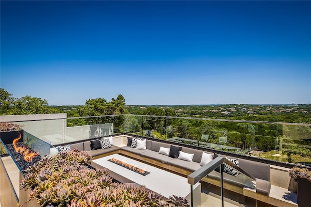 balcony featuring an outdoor living space with a fire pit