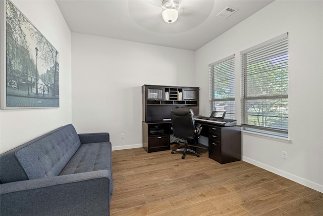 office area featuring light hardwood / wood-style flooring and ceiling fan