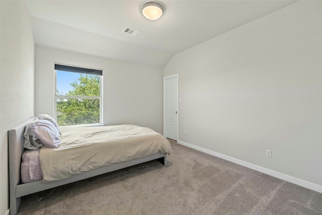 carpeted bedroom with vaulted ceiling, visible vents, and baseboards