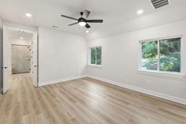 spare room with lofted ceiling, light hardwood / wood-style flooring, and ceiling fan