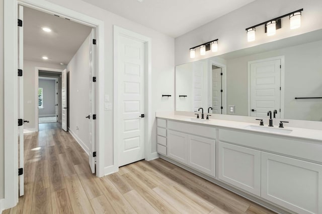 bathroom featuring vanity and hardwood / wood-style floors