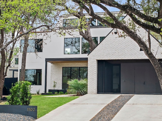 modern home with a front lawn