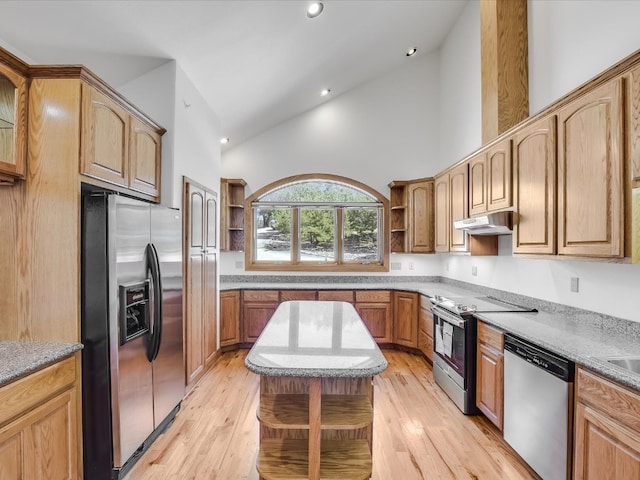 kitchen featuring appliances with stainless steel finishes, sink, high vaulted ceiling, and light hardwood / wood-style flooring