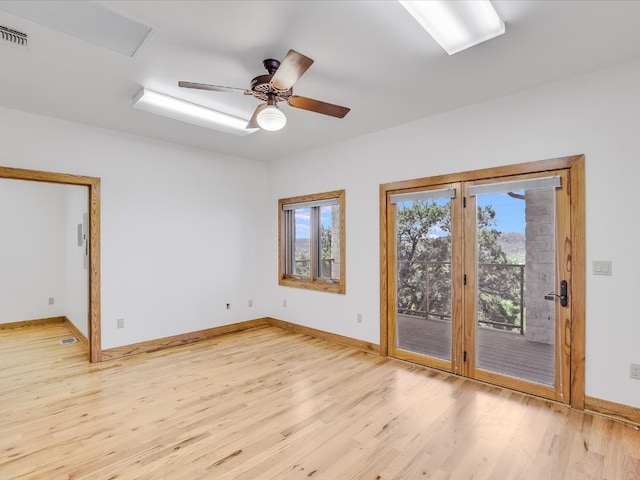 spare room featuring light hardwood / wood-style flooring and ceiling fan