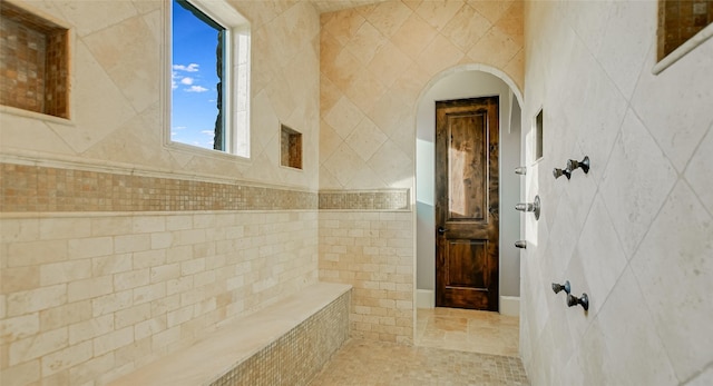 bathroom featuring tile flooring and tile walls