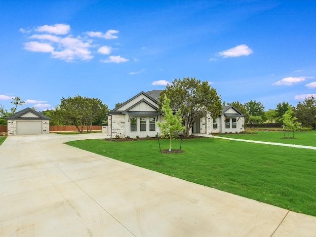 view of front of property with a front yard and a garage