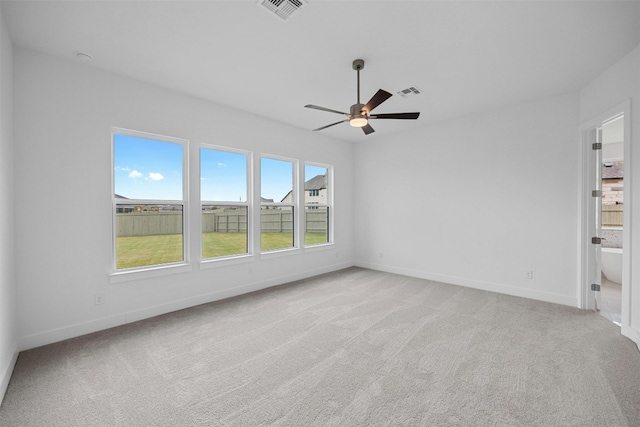 unfurnished room with light colored carpet and ceiling fan