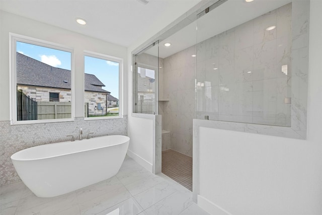 509 Sierra Lisa Cv, Liberty Hill, TX 78642 - bathroom featuring a soaking tub, walk in shower, marble finish floors, and recessed lighting