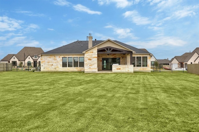 509 Sierra Lisa Cv, Liberty Hill, TX 78642 - back of property featuring stone siding, a fenced backyard, ceiling fan, a patio area, and a chimney